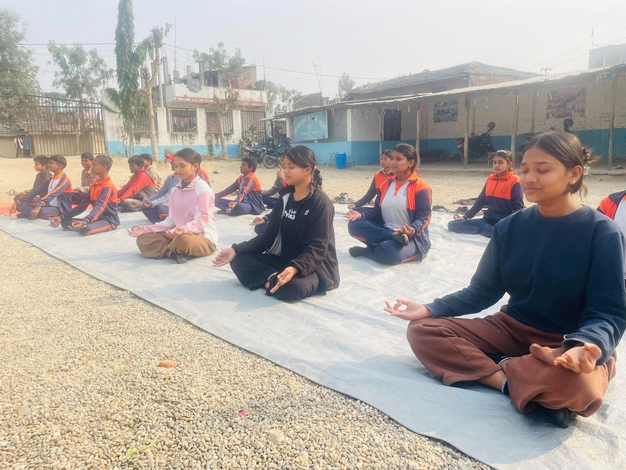 Students in seated meditation at sunrise