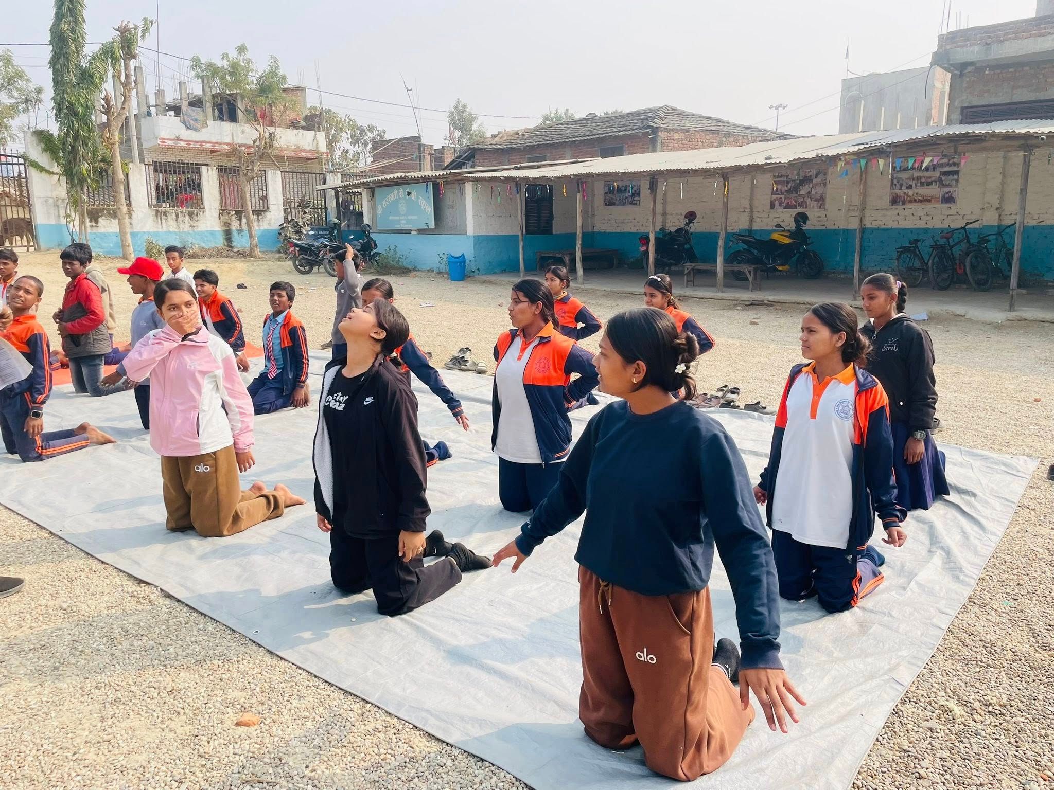 Students practicing yoga in the school courtyard